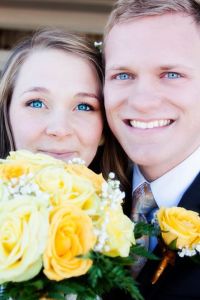 Newlyweds with bright eyes and glowing faces outside a Mormon temple