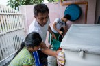 father and three of his children work together to wash a car